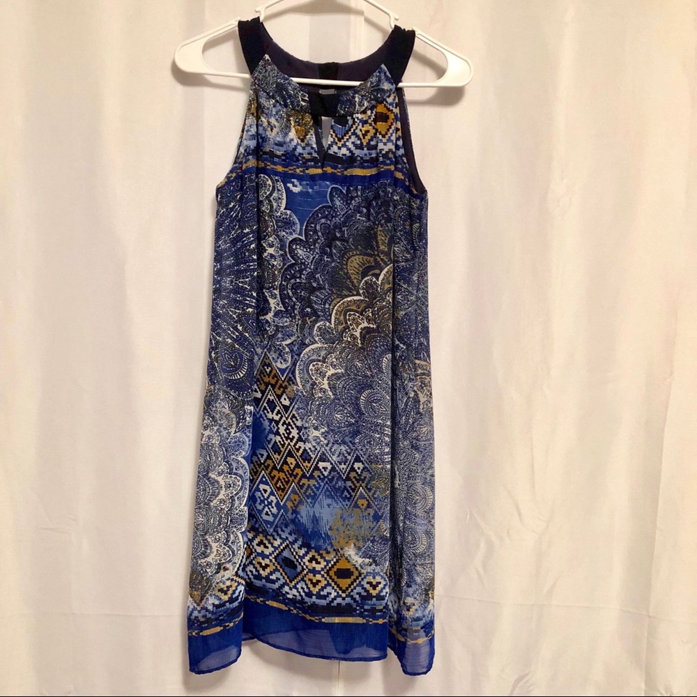 This is a sleeveless navy blue print top.